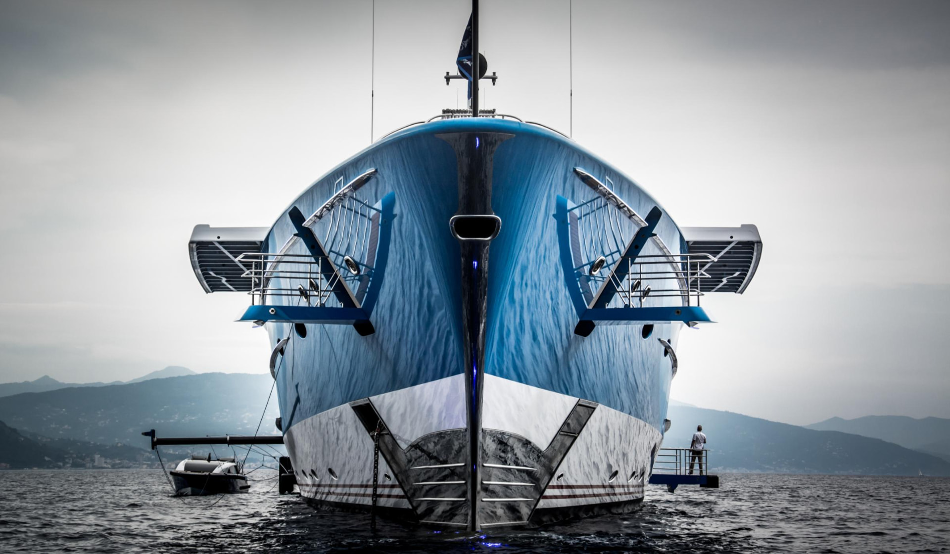 Superyacht with C-Quip tender booms deployed to manage tenders alongside