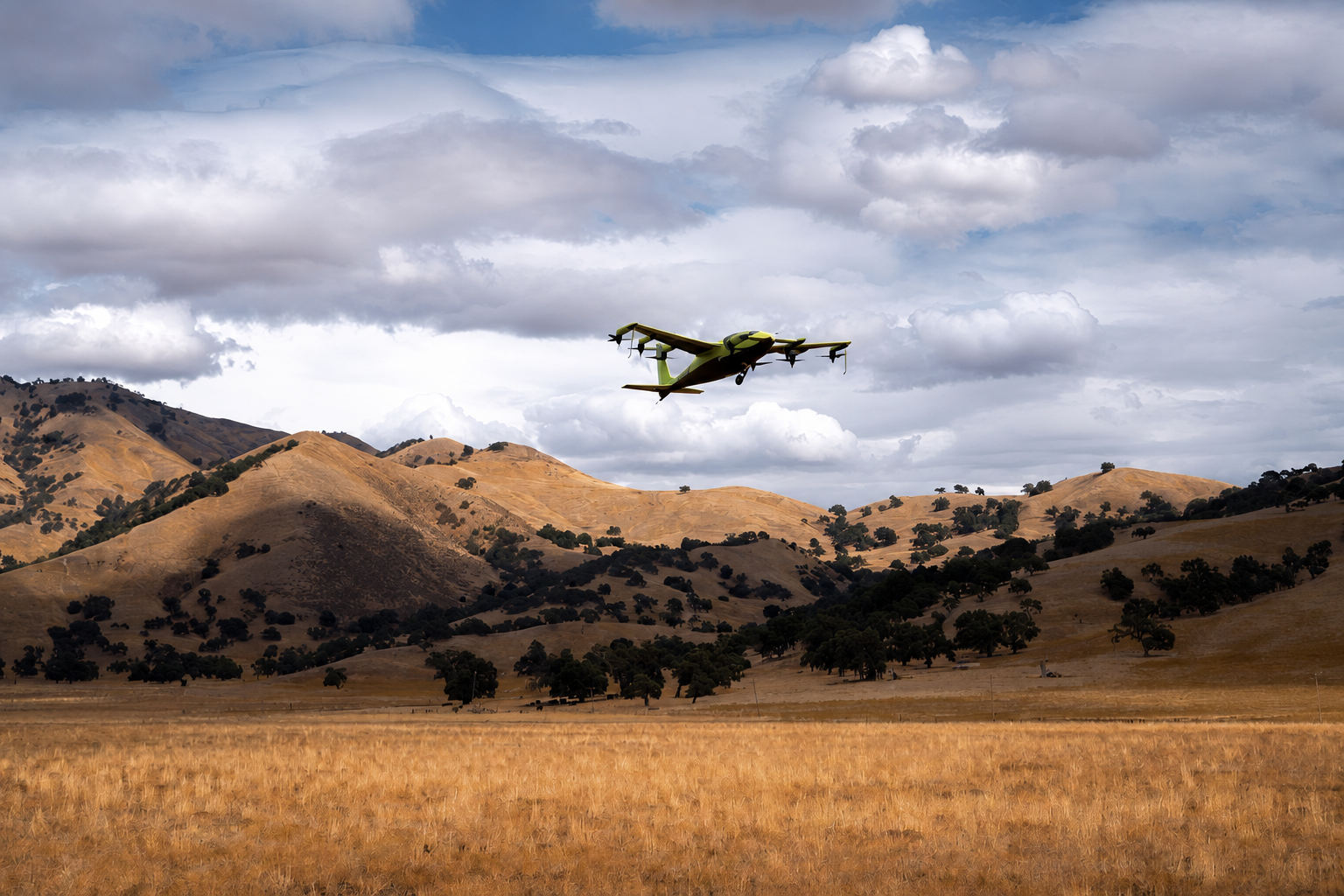Electric vertical take-off aircraft in flight above open countryside