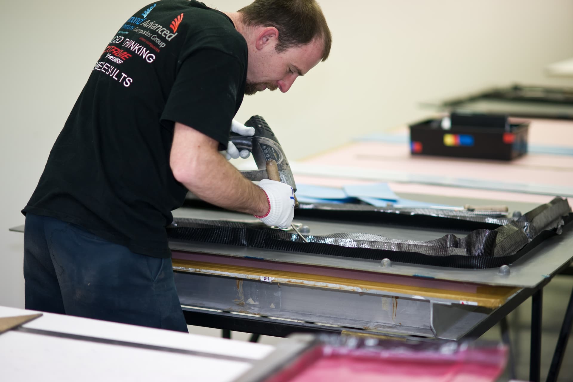 Composite technician laying up pre-preg carbon fibre in a mould