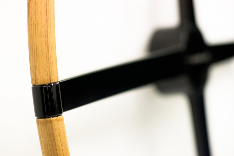 Detail of a bespoke carbon fibre steering wheel with timber rim
