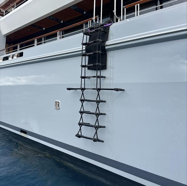 C-Quip carbon fibre pilot ladder rigged against a superyacht hull over the rub rail