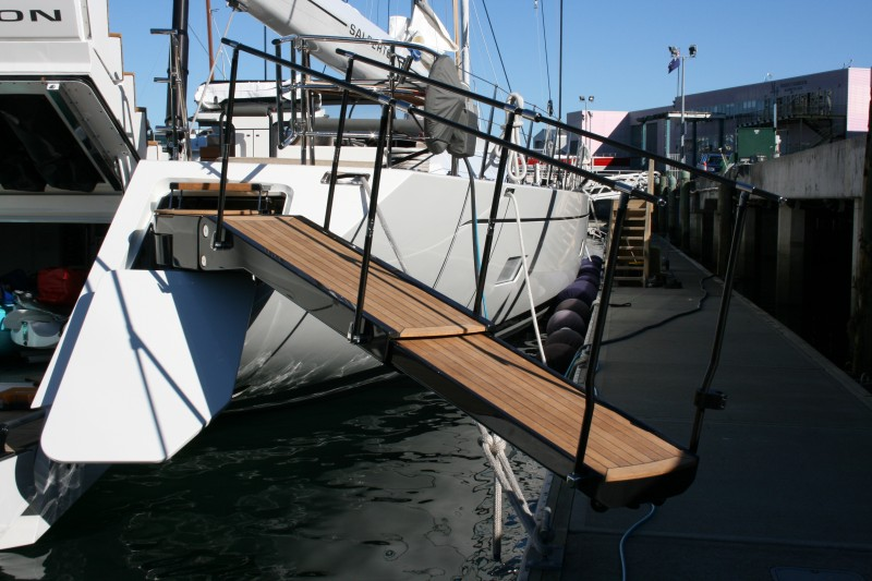 Custom carbon fibre boarding platform connecting a yacht stern to the dock