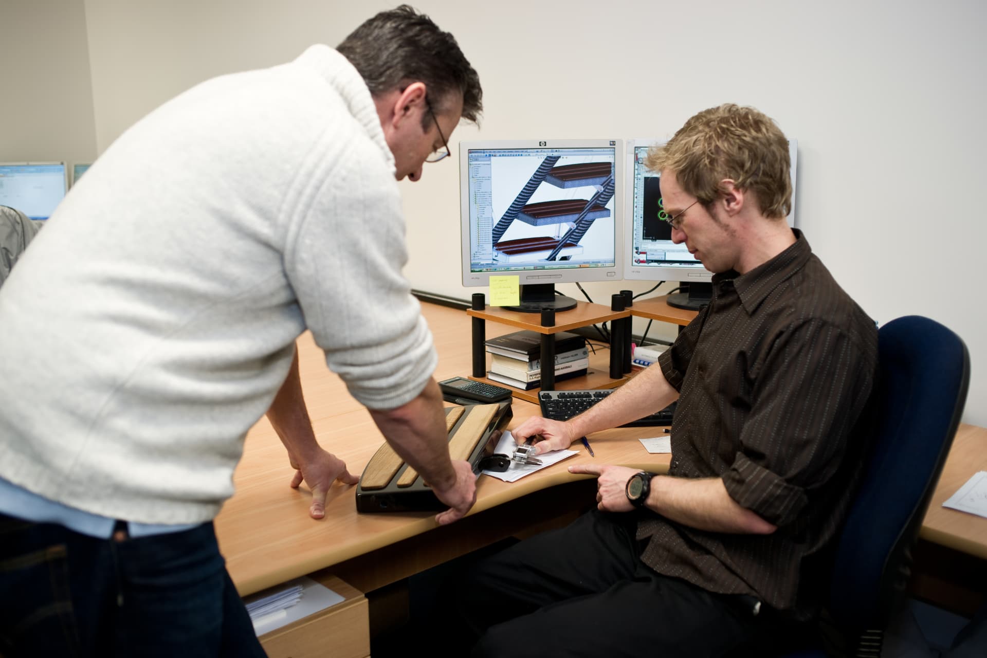 C-Quip engineers reviewing a 3D model of boarding equipment