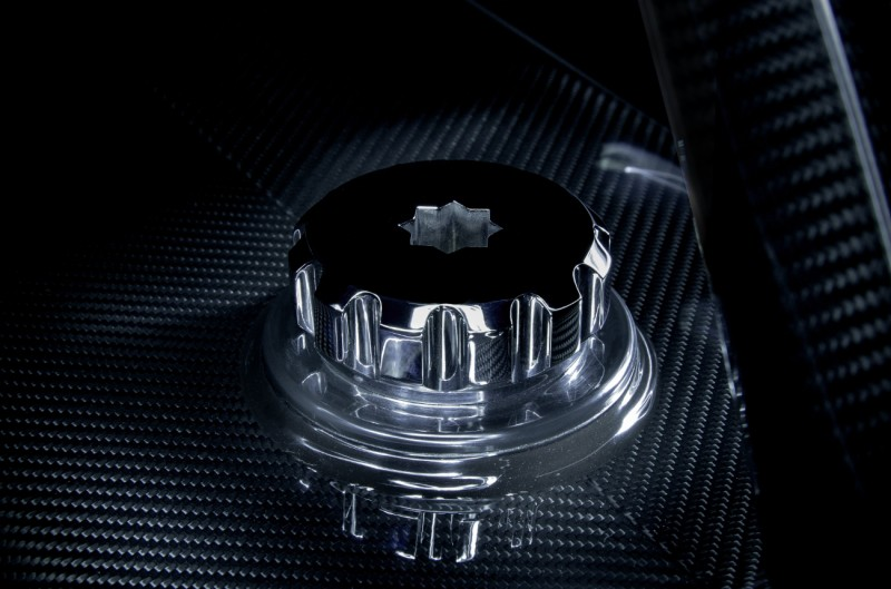 Polished stainless steel deck socket fitting set into a carbon fibre tender fender base